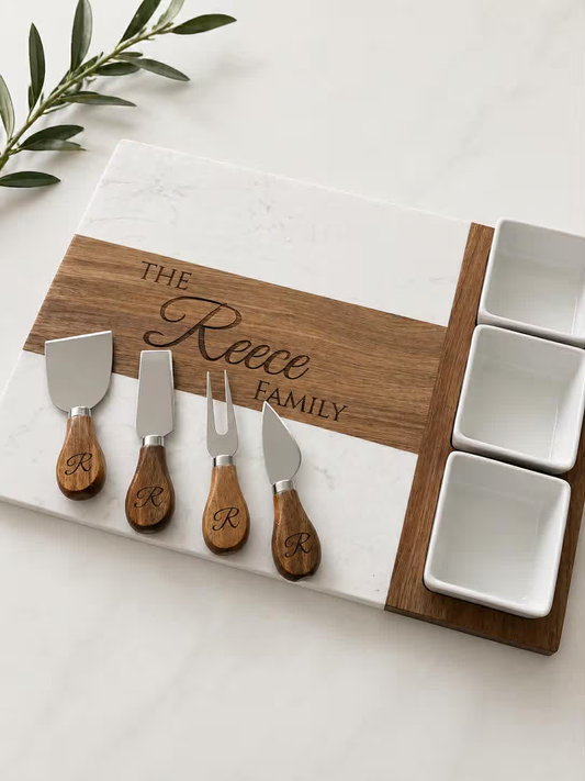 Personalized marble and acacia charcuterie board set with engraved family name and serving accessories
