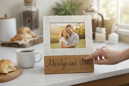 Personalized laser engraved wood and marble picture frame with couple names on a kitchen counter